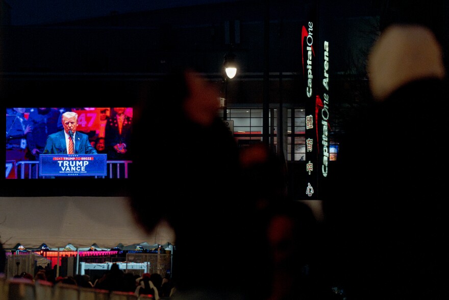 A spattering of Donald Trump supporters watch his pre-inauguration rally after waiting in line for hours, only to be turned away on Sunday, Jan. 19, 2025, at Capital One Arena in Washington D.C.