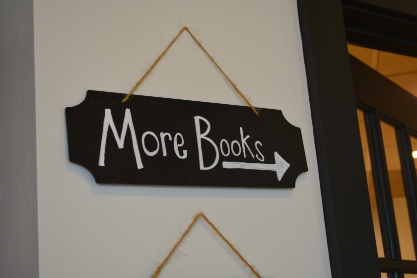 Sign points to more books at Novel Idea Book Shop Jan. 2, 2025.JPG