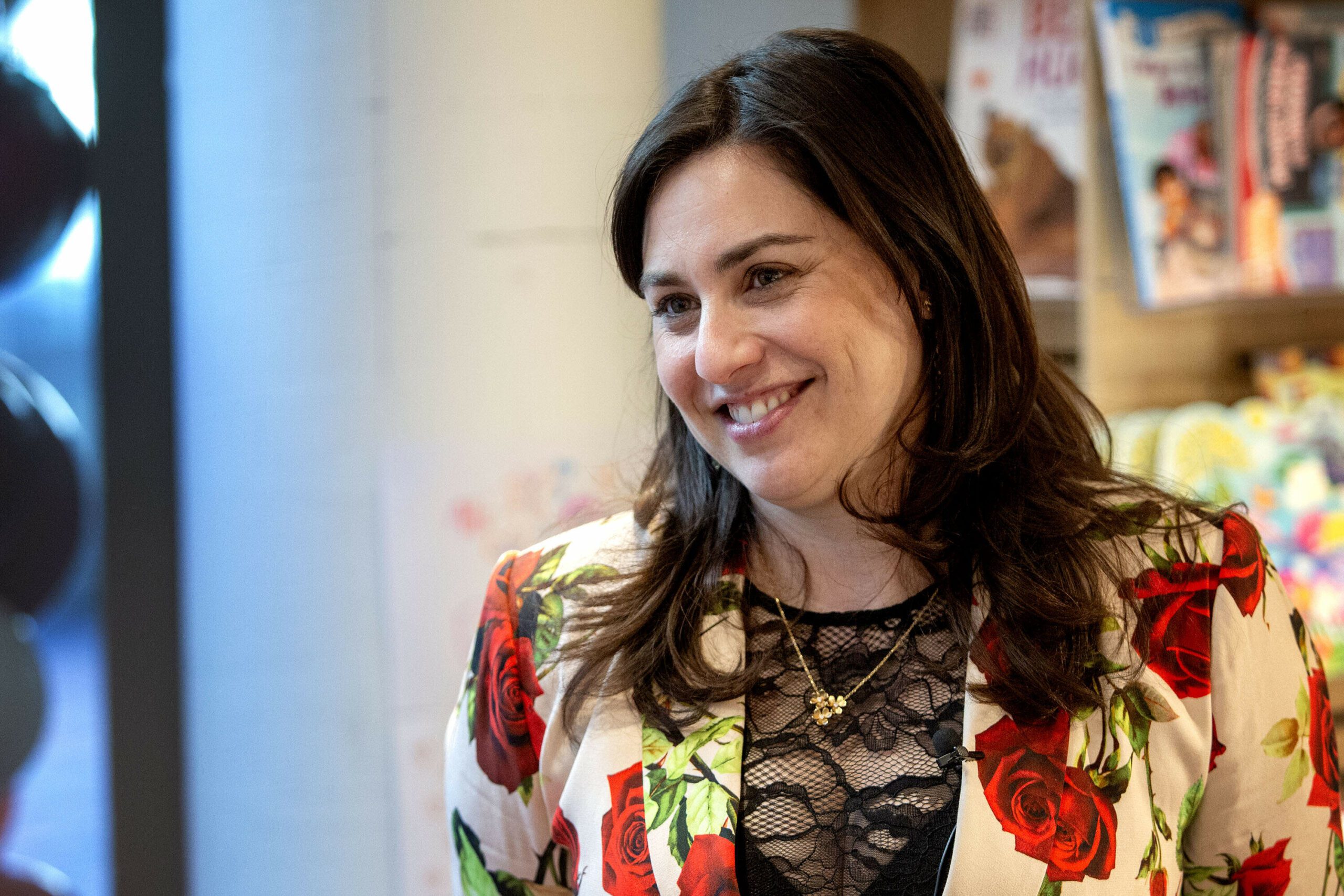 Lovestruck Books owner Rachel Kanter talks with visitors at the store in Cambridge, Mass. (Robin Lubbock/WBUR)