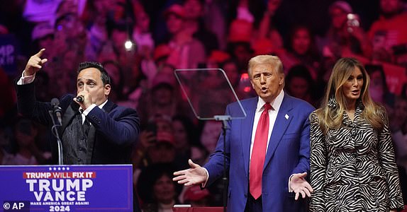 FILE - Republican presidential nominee former President Donald Trump, center, and former first lady Melania Trump, right, listen to opera singer Christopher Macchio at a campaign rally at Madison Square Garden, Oct. 27, 2024, in New York. (AP Photo/Evan Vucci, File)