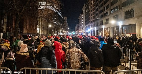 WASHINGTON, DC - JANUARY 20: People wait on line to get into Capital One Arena for Donald Trump's inauguration celebration on January 20, 2025 in Washington, DC. U.S. President-elect Donald Trump and Vice President-elect JD Vance will be sworn in on January 20 in an indoor ceremony in the rotunda of the U.S. Capitol with a celebration at the Arena after. (Photo by Stephanie Keith/Getty Images)