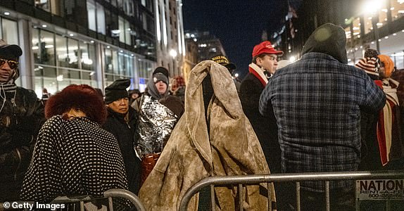 WASHINGTON, DC - JANUARY 20: People wait on line to get into Capital One Arena for Donal Trump's inauguration celebration on January 20, 2025 in Washington, DC. U.S. President-elect Donald Trump and Vice President-elect JD Vance will be sworn in on January 20 in an indoor ceremony in the rotunda of the U.S. Capitol with a celebration at the Arena after. (Photo by Stephanie Keith/Getty Images)