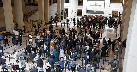 WASHINGTON, DC - JANUARY 08: People wait in line in the Capitol Visitor Center to visit the casket with the remains of former U.S. President Jimmy Carter on Capitol Hill on January 08, 2025 in Washington, DC. Carter's body will lie in state in the Capitol Rotunda until a funeral service at the National Cathedral in Washington on January 9. Carter, the 39th President of the United States, died at the age of 100 on December 29, 2024 at his home in Plains, Georgia.  (Photo by Anna Moneymaker/Getty Images 2025)