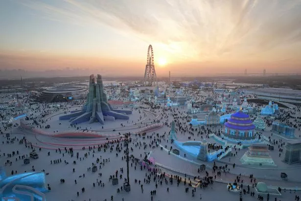 This photo shows an aerial view of people visiting the Harbin Ice and Snow World