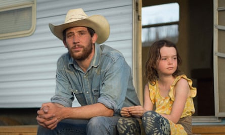 a man in a cowboy hat sits next to a girl