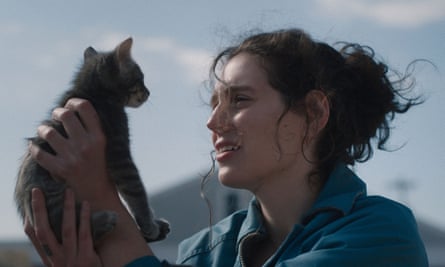 a woman holding a kitten