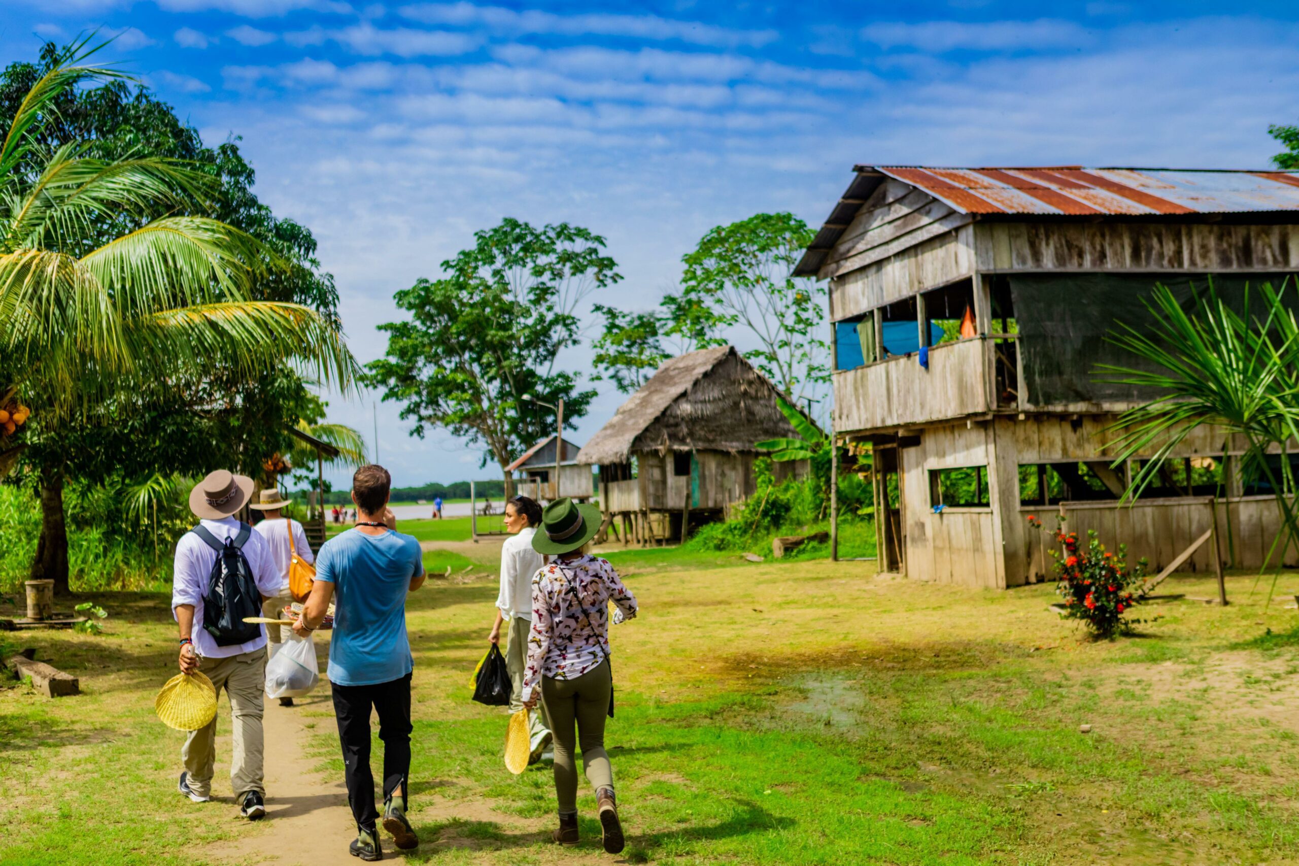 Tourists walking through an Amazon village.