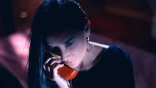 demi moore as elisabeth sparkle on the phone in the substance