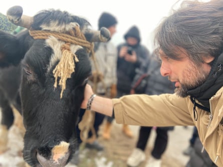 Oleh Kokhan with a cow during filming for War Through the Eyes of Animals.