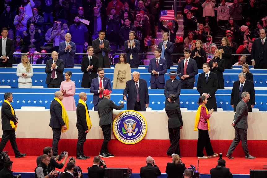 Families of hostages held in Gaza line up to greet Donald Trump at his indoor inauguration.