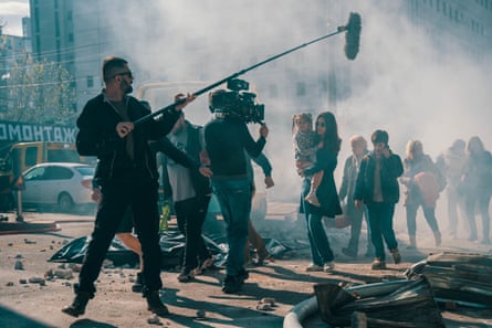 A man holds a microphone on a film set