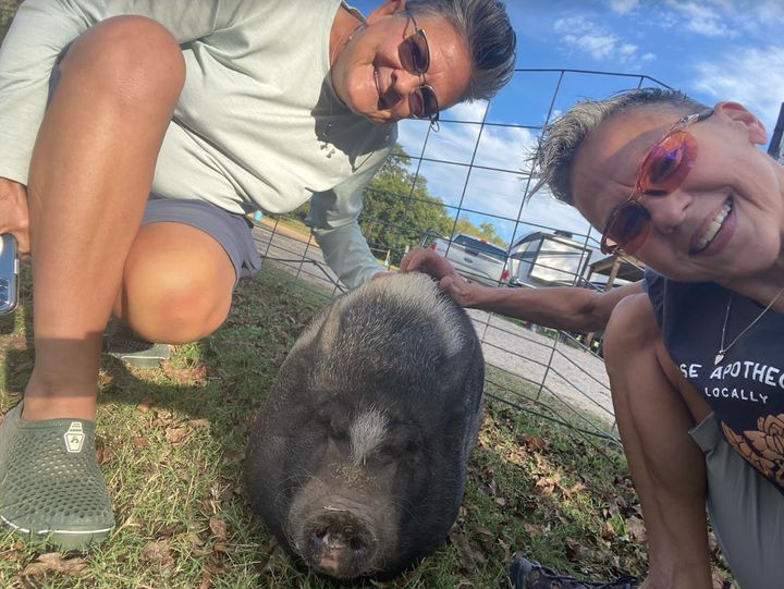 The author and her wife with Minnie Pearl, the pig at Lone Star Bar in Fredericksburg, Texas, in October 2021.