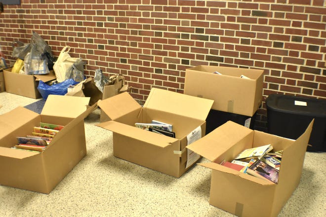 Boxes full of donated books from Kohler Elementary School classrooms in a Kohler High School hallway, as seen, Friday, January 17, in Kohler, Wis.