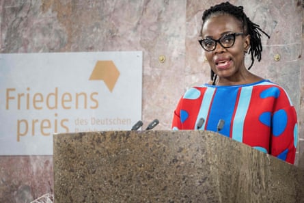 A woman makes a speech at a podium