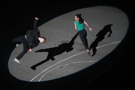 A still from the film showing two actors shot from above in a spotlight