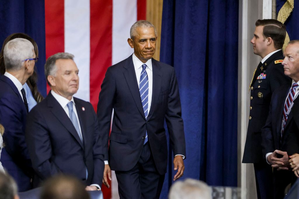 Barack Obama played it cool, as always, in a tailored navy suit, crisp white shirt, and striped tie.