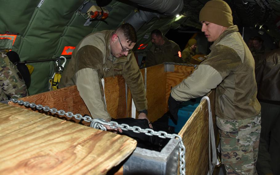 Airmen load duffle bags on a U.S. Air Force KC-135