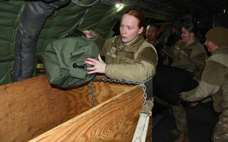 Airmen load duffle bags on a U.S. Air Force KC-135