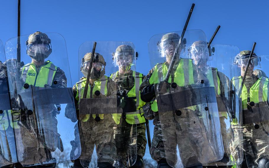 Wyoming National Guardsmen train with riot shields, batons, and protective equipment