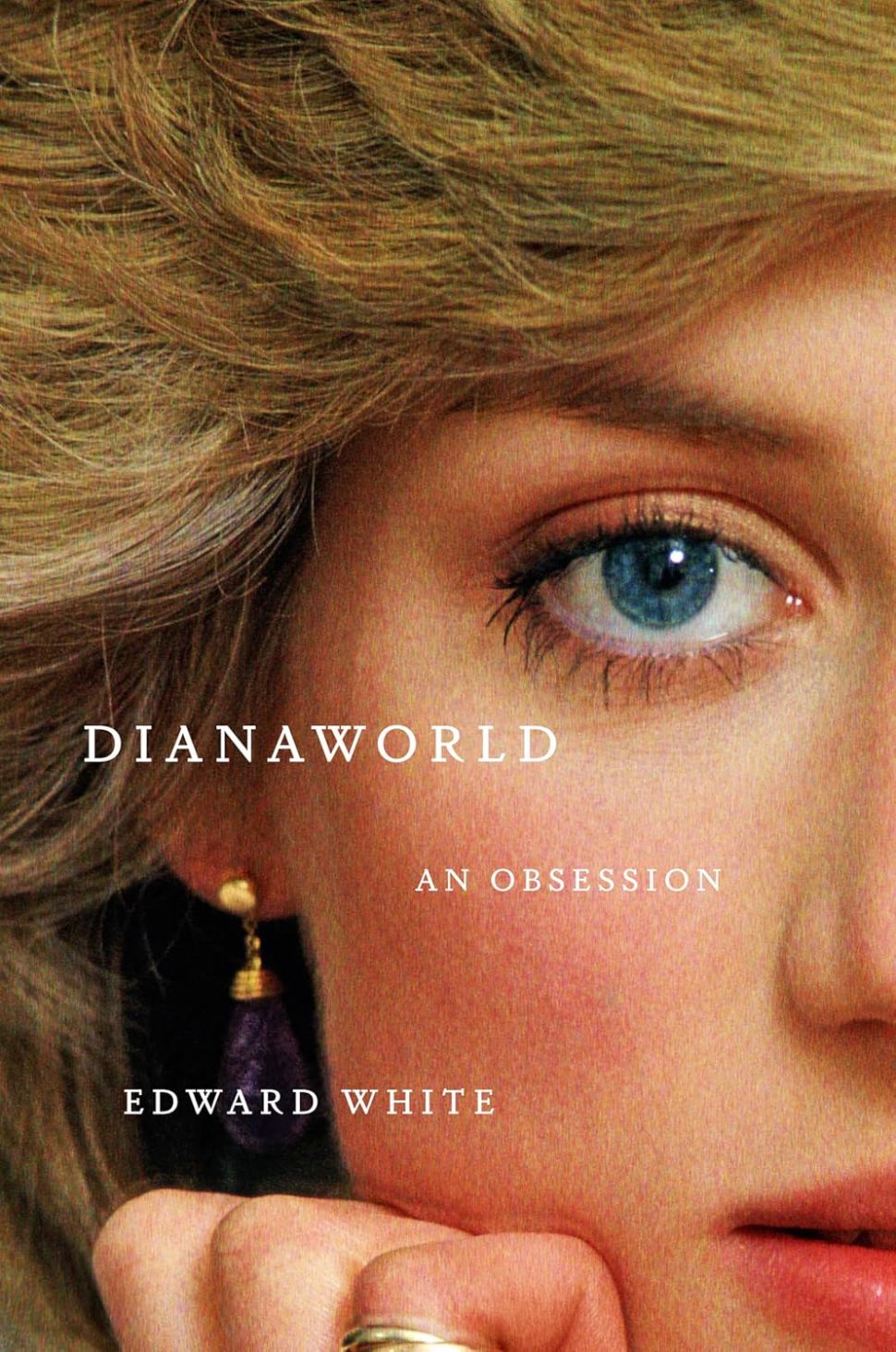 An image of the book cover for Dianaworld by Edward White, showing an extreme close-up of Princess Diana’s face, particularly her blue eye and blonde hair, with the title in white uppercase letters across the center.