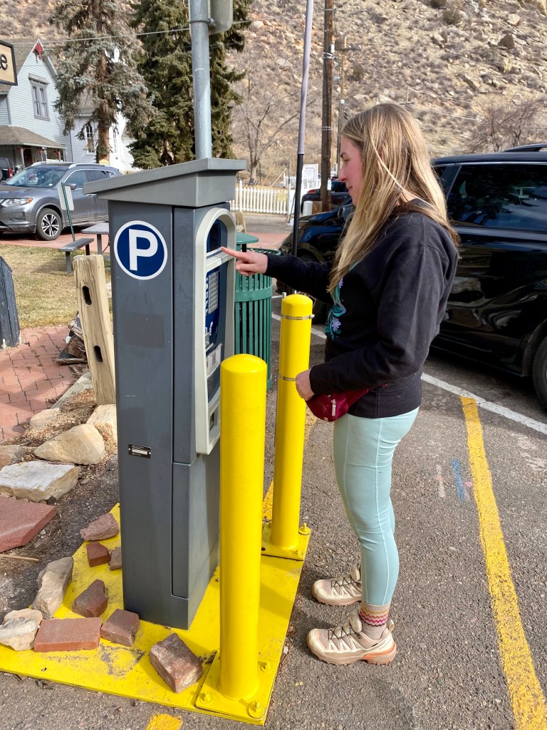 woman using parking kiosk