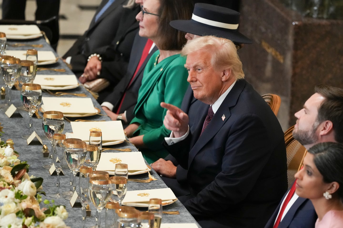 President Donald Trump gestures as he attends an inaugural luncheon inside Statuary Hall at the Capitol in Washington on Monday, Jan. 20, 2025. 