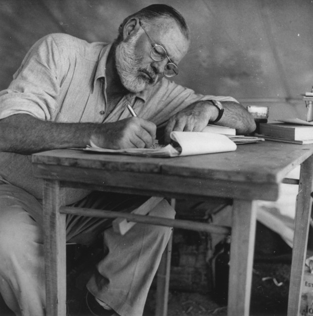 Ernest Hemingway writing in Kenya