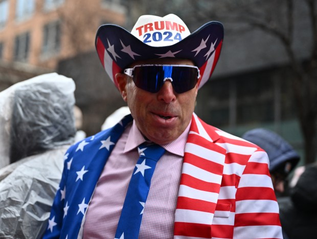 A supporter of US President-elect Donald Trump waits in line outside Capital One Arena in Washington, DC, before yesterday's pre-Inauguration rally. (Photo by Angela Weiss/AFP via Getty Images)