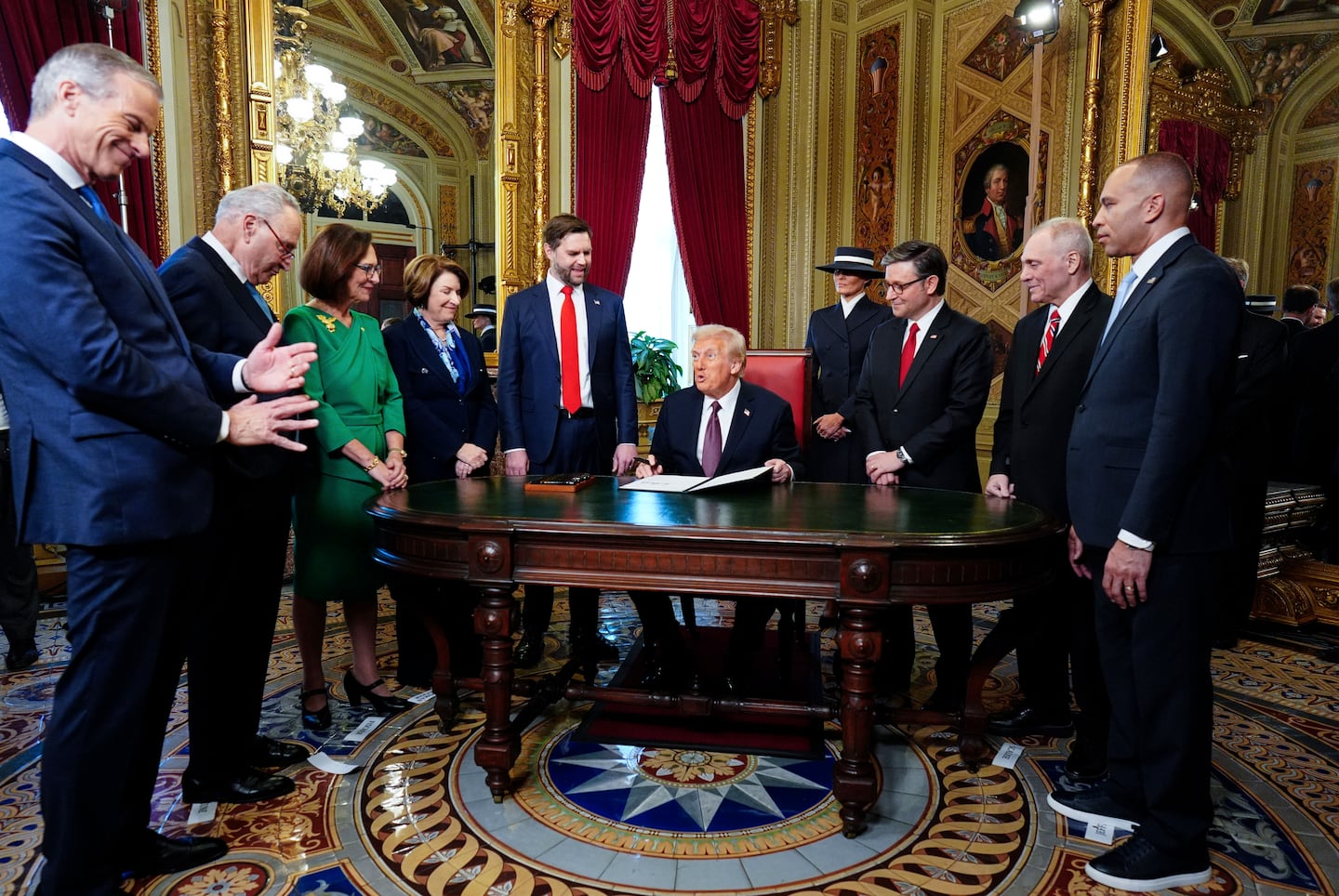 President Donald Trump, center, takes part in a signing ceremony in the President's Room after the 60th Presidential Inauguration, Monday, Jan. 20, 2025, at the US Capitol in Washington. 