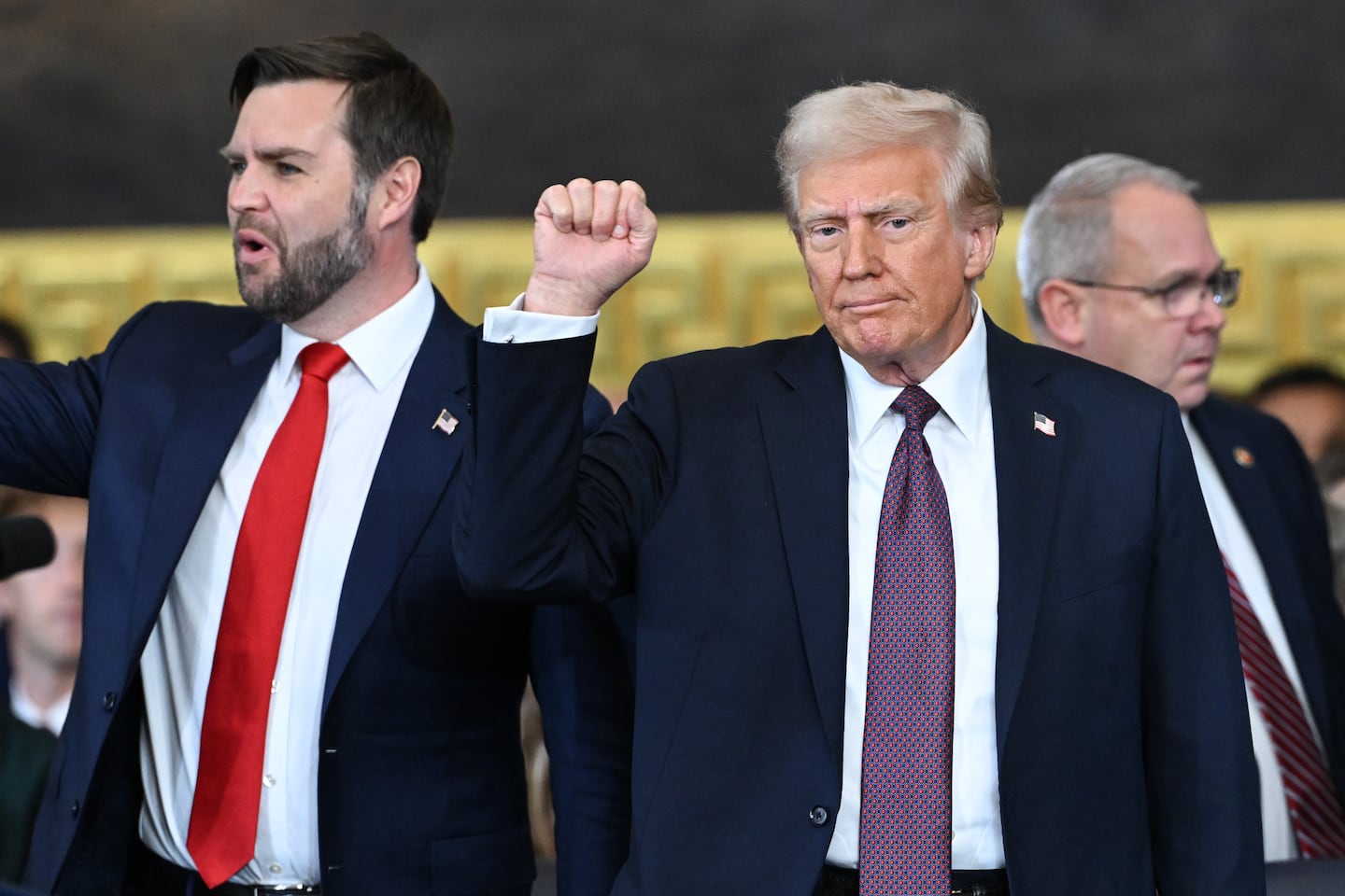 Donald Trump raises a fist after being sworn in as president as Vice President J.D. Vance stands by his side in the US Capitol Rotunda on Jan. 20, 2025 in Washington, D.C. 