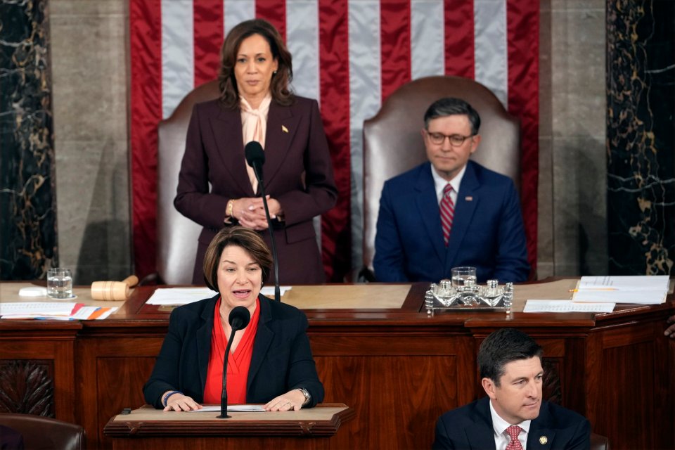 Vice President Kamala Harris stands with House Speaker Mike Johnson as a joint session of Congress convenes to confirm the Electoral College vote