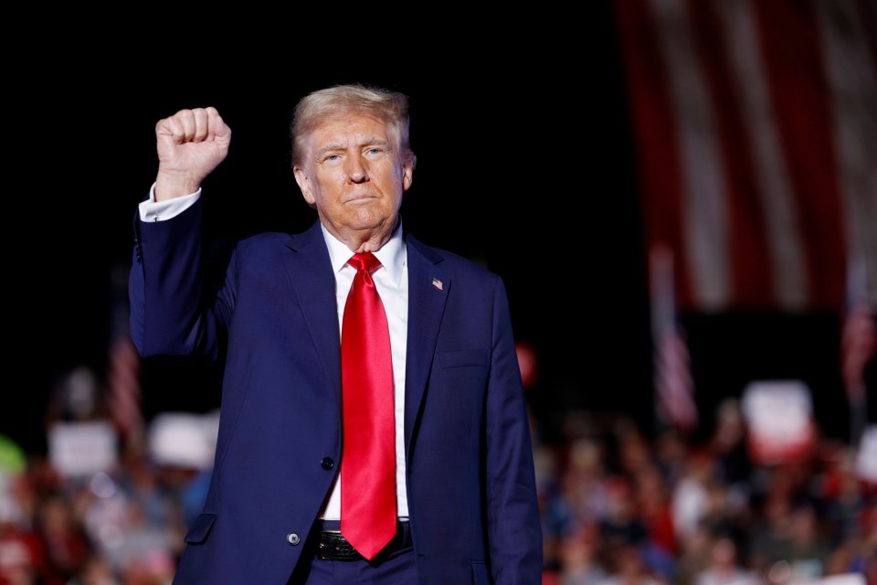 Donald Trump holds up his fist as he walks offstage at the end of a campaign rally at the Butler Farm Show fairgrounds on October 5 in Butler, Pennsylvania