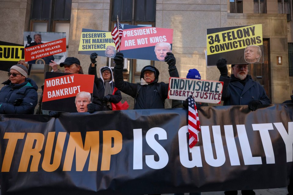 Anti-Trump demonstrators protest outside Manhattan criminal court before the start of the sentencing of the president-elect