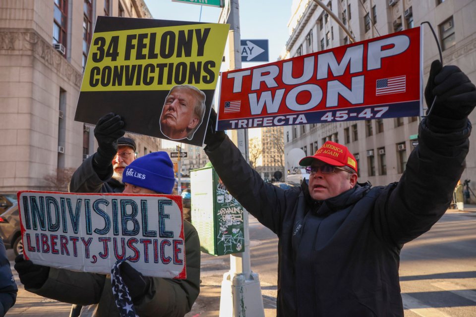 Protesters holding up anti-Donald Trump signs outside the Lower Manhattan courthouse