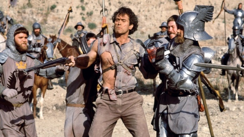 Ash (Bruce Campbell) surrounded by medieval knights in Army of Darkness