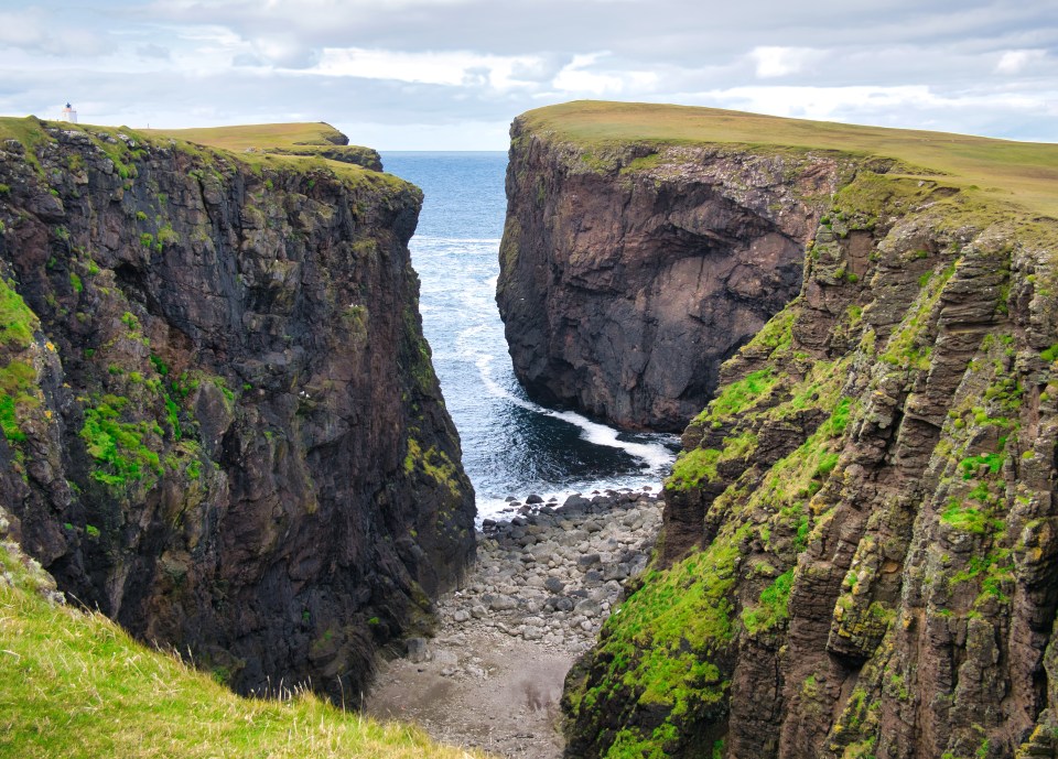 Sea inlet between high cliffs in Eshaness, Shetland.