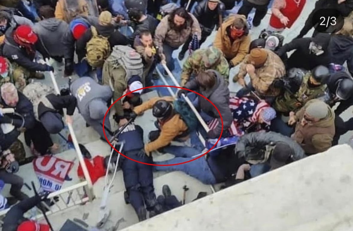 A person is circled in an exhibit showing a chaotic crowd scene in which a police officer appears to be laying on the ground.