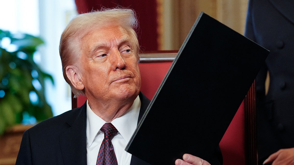 Donald Trump takes part in a signing ceremony after his inauguration