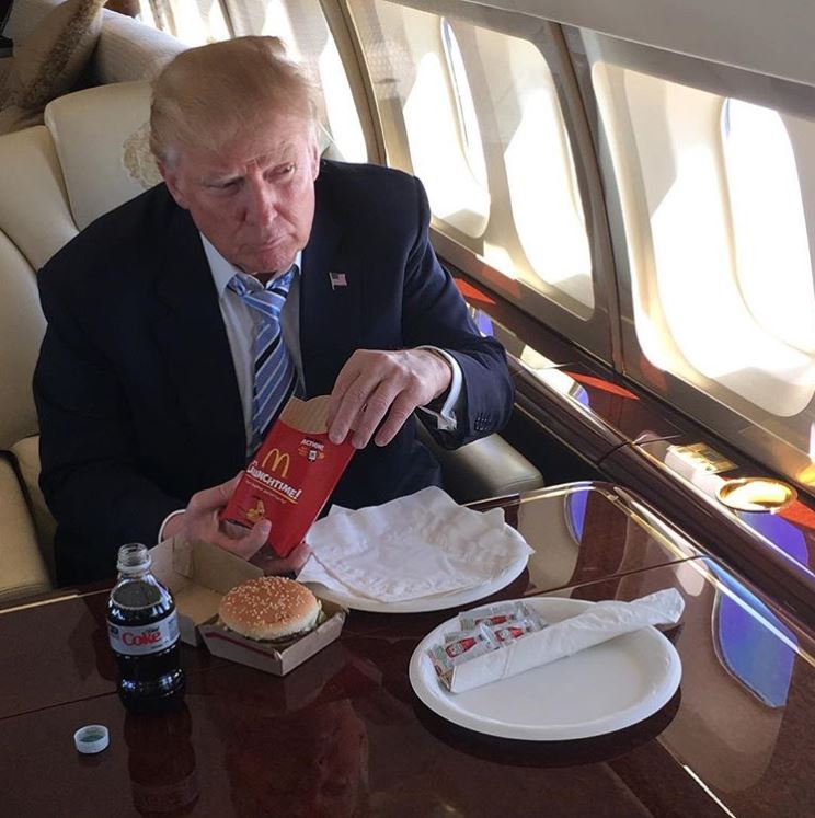 Donald Trump eating McDonald's on a private jet.