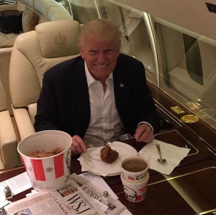 Donald Trump eating KFC on a private jet.