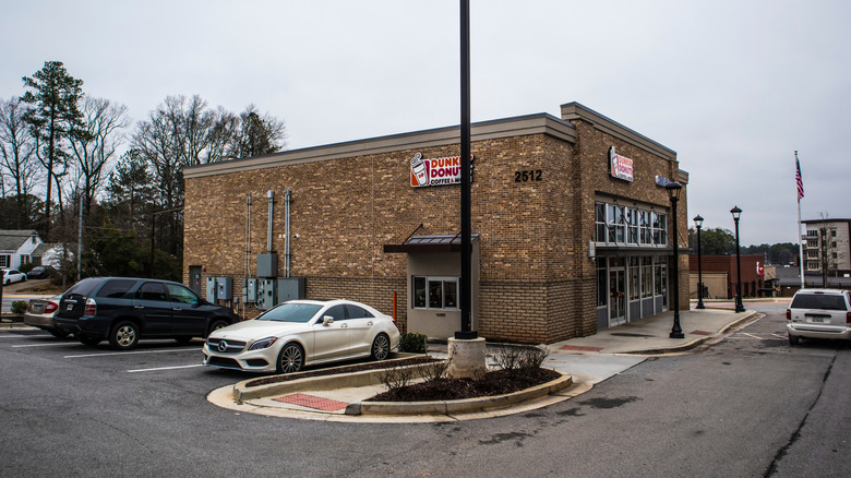 Cars parked by Dunkin' Donuts