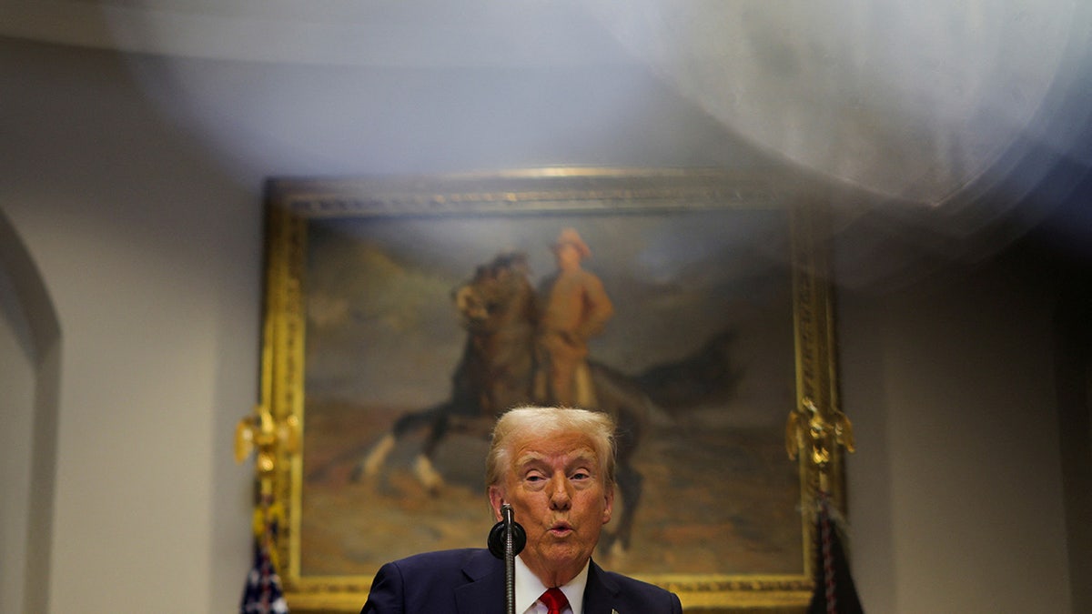 Donald Trump stands after delivering remarks on AI infrastructure at the Roosevelt room at White House