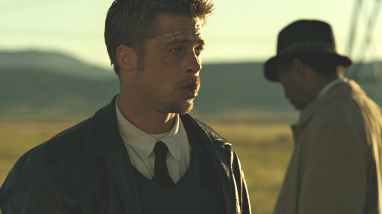 Brad Pitt and Morgan Freeman as David Mills and William Somerset, recovering in an open field after a murder in Seven