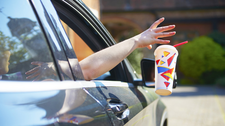 Person throwing trash out of car