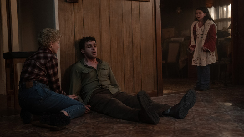 Christopher Abbott as Blake suffering from mysterious symptoms, while Julia Garner's Charlotte and Matilda Firth's Ginger look concerned in Wolf Man