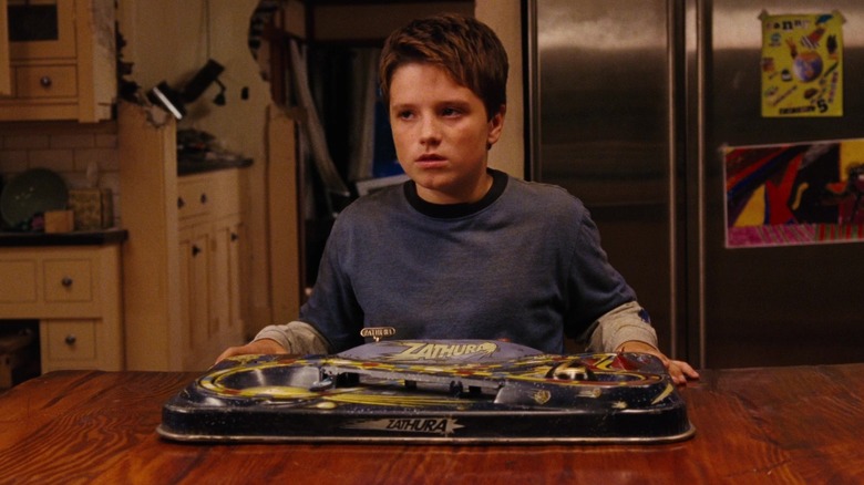 Josh Hutcherson as Walter holding the board game in 