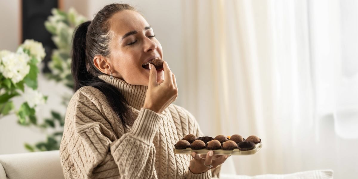 0_A-young-woman-couldnt-resist-the-sweet-temptation-to-eat-chocolate-candies-and-enjoys-them-with-her-eyes-closed.jpg