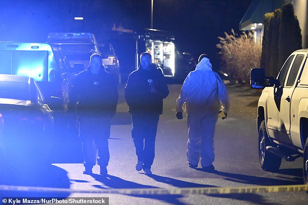 Pictured: Investigators at the crime scene in Boston where Nuno Loureiro was fatally shot
