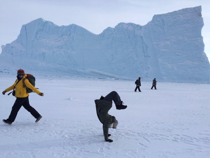 The author expressing her dancer self in front of an iceberg in Northern Greenland during a day off from work at NASA.