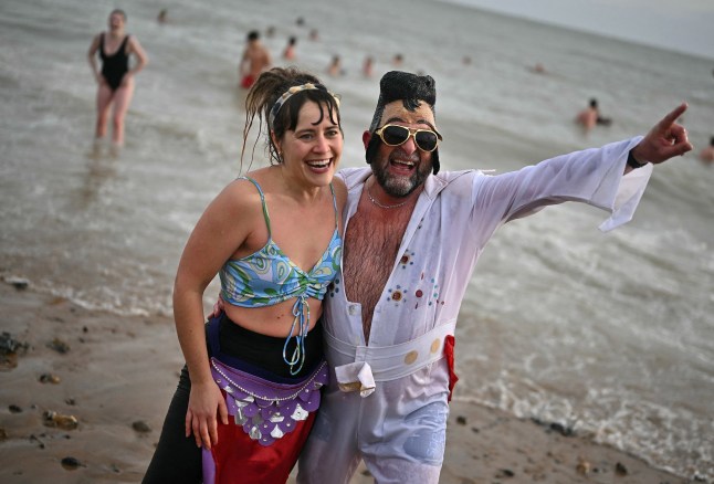 People take part in the annual New Year's Day Dip, on the beach in Ramsgate, south east England on January 1, 2024.